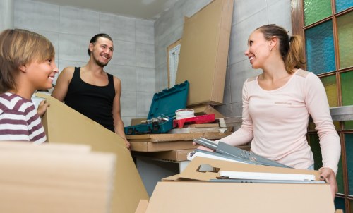 Movers handling a Docklands apartment move with boxes and furniture