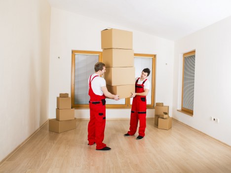 Moving crew handling office items near Docklands towers